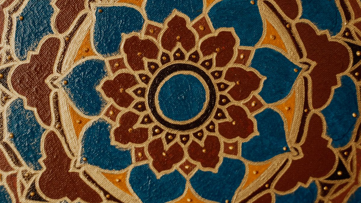 Ornamental mandala with blue, brown and gold geometric patterns
